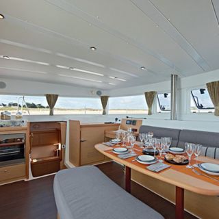 The main saloon on a Lagoon 52 with table set for guests